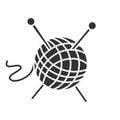 Wool clew with knitting needles glyph icon