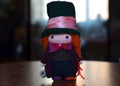 Wool doll character Willy Wonka on a wooden table, bright doll in a hat and bow tie, doll in the form of a movie character