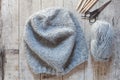 Wool grey hat, knitting needles and yarn