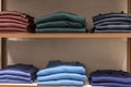 Wool jumpers in different colors on the wooden shelves of the store. New autumn winter collection. Front view Royalty Free Stock Photo