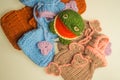 Wool knitted toy frog with baby booties background Royalty Free Stock Photo