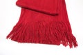 Wool red scarf with fringe on a white background Royalty Free Stock Photo