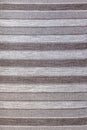 Wool rustic rug with gray, white and black stripes, texture background