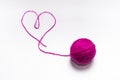 Wool skein pink with a thread in the shape of a heart on a white background
