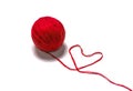 Wool skein red thread in the shape of heart on white background Royalty Free Stock Photo