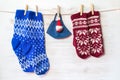 Wool socks, mittens and Santa Claus toy on protective face mask, hanging over wooden background Royalty Free Stock Photo