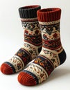 Wool Socks Pair with Intricate Fair Isle Pattern in Red White and Navy on White Background Royalty Free Stock Photo