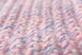 Wool textured pattern background with pink and blue threads. Soft focus