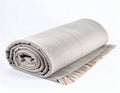 Handmade decor. Wool throw blanket on a white background. Rolled up comforter. Light natural color Royalty Free Stock Photo