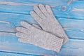Woolen womanly gloves for autumn or winter on old blue boards