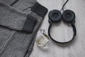 Woolen sweatshirt , a bottle of perfume and black headphones.