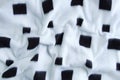Woolen white plaid close-up with square black print