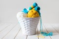 Woolen yarn in coils and tangles in a white basket. A table made Royalty Free Stock Photo