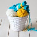 Woolen yarn in coils and tangles in a white basket. A table made Royalty Free Stock Photo