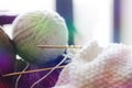 Woolen yarn for knitting. Close-up shots of white ball of natural wool yarn and knitting needles Royalty Free Stock Photo