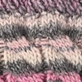 Woollen knitted hat close up, wool texture in pink and grey Royalty Free Stock Photo