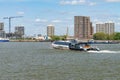 Uber boat speeding past Woolwich Ferry terminal on river Thames