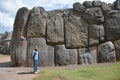 Woman and Sacsayhuaman Ruins, Cuzco, Peru.