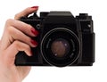 Woomans hand with red nails holding a camera