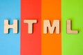 Word or abbreviation HTML, meaning HyperText Markup Language as internet programming language, is on background of four colors: bl