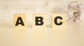 The word ABC consists of wooden cubes with letters, top view on a light background Royalty Free Stock Photo