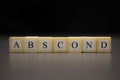 The word ABSCOND written on wooden cubes isolated on a black background