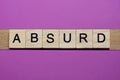 Word absurd from small gray wooden letters