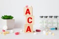 Word ACA Affordable Care Act on wooden cubes on blue background with stethoscop Royalty Free Stock Photo