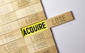 word Acquire on wooden block Royalty Free Stock Photo