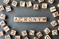 The word acronym wooden cubes with burnt letters