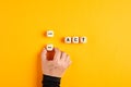 The word act on wooden blocks with a male hand choosing the now option. Taking action Royalty Free Stock Photo
