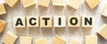 The word ACTION consists of wooden cubes with letters, top view on a light background Royalty Free Stock Photo