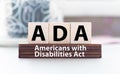 Word ADA Americans with Disabilities Act is made of wooden building blocks. Concept Royalty Free Stock Photo