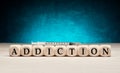 The word addiction on wooden cubes with syringe. Drug or substance addiction concept Royalty Free Stock Photo