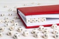 Word Admin written in wooden blocks in red notebook on white woo