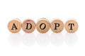 Word Adopt from circular wooden tiles with letters children toy.