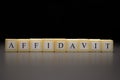 The word AFFIDAVIT written on wooden cubes isolated on a black background