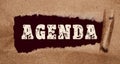 The word Agenda appearing behind torn brown paper. Conceptual image Royalty Free Stock Photo