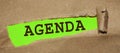The word Agenda appearing behind torn brown paper. Planning in business management concept Royalty Free Stock Photo