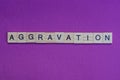 Word aggravation from small gray wooden letters