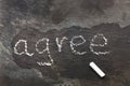 The word agree written with chalk on black stone. Royalty Free Stock Photo