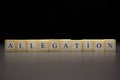 The word ALLEGATION written on wooden cubes isolated on a black background