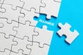 The word alliance written on missing puzzle piece. Teamwork, unity and cooperation Royalty Free Stock Photo