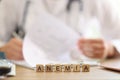 Word anemia on table and blurred doctor filling out medical paperwork in background. Royalty Free Stock Photo