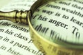 The word `anger` emphasized by a magnifying glass.