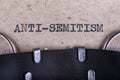 The word anti-semitism written in typewriter font. The inscription in the old style on gray paper Royalty Free Stock Photo