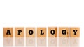 The word Apology on seven wooden cubes