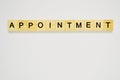 Word appointment. Top view of wooden blocks with letters on white surface