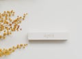 The word APRIL on wooden cube and mimosa flower on white background. Easter, Springtime, Hello April concept.