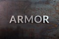 The word armor laid with silver metal letters on rusted iron flat surface background Royalty Free Stock Photo